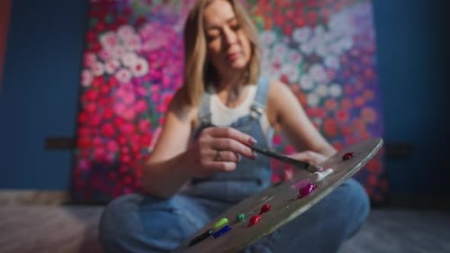 Woman Artist Preparing Paint on Palette in Art Studio