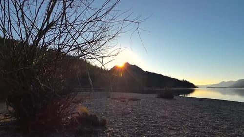 Sunset on a lake with mountains in background