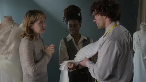 Designers Discussing Fabric in Fashion Design Workplace