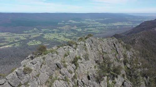 Aerial retreats from steep, craggy Sugarloaf peak in Victoria, AUS