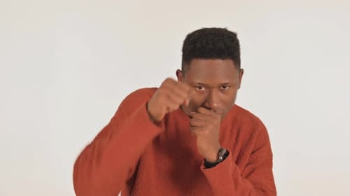 Man in Sweater Shadow Boxing on White Background