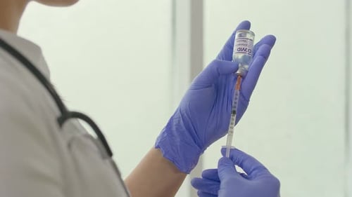 Closeup A Vial of the COVID19 Coronavirus Vaccine is Being Used By a Scientist