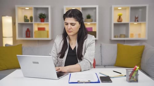Home office worker woman working on laptop.