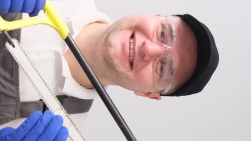 A Saw in the Hands of a Carpenter's Man Home Renovation Concept Vertical Video