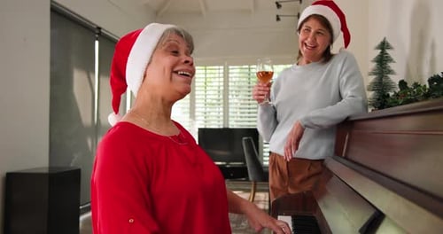 Festive Women Celebrate Christmas Singing at Piano