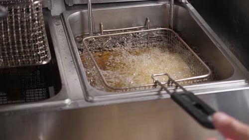 Deep Fryer Bubbling with Food Cooking