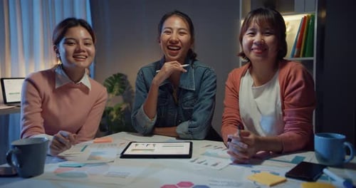 Female Team Collaborating Late in Office at Night