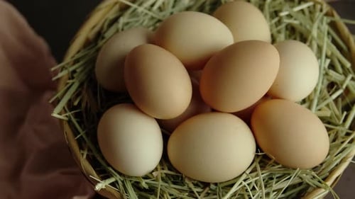 Organic Eggs And Hay In A Wicker Basket, Dolly In Close Up
