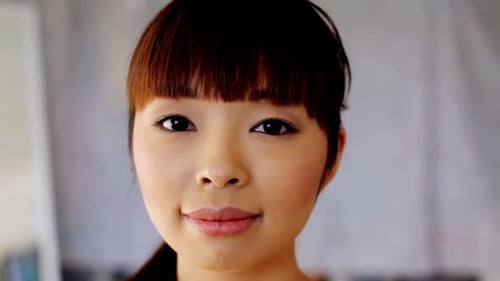 Smiling Young Woman Close-Up Headshot in an Indoor Setting