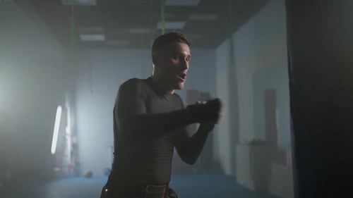 Professional Fighter Trains His Punches and Defense in the Boxing Gym a Man Boxer Beats a Punching