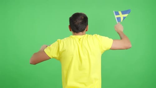 Rear View of a Man Waving a Swedish Pennant