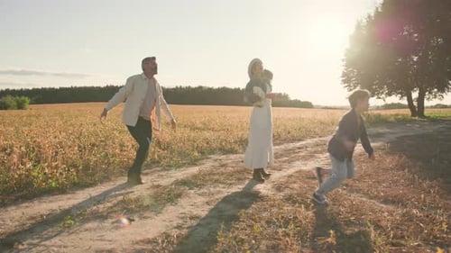 Lovely Parent Stand Children Run with an Air Kite in Field on Sunset Dad Girl Outdoor Outside Fly
