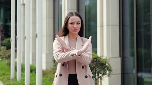 Concerned Woman Showing Cross with Arms and Making No Way Gesture
