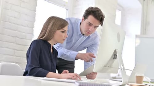 Close up of Startup Team Discussing on Tablet using Desktop