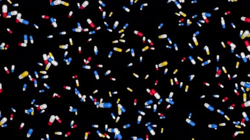 Cápsulas coloridas de medicamentos se están cayendo en 3D