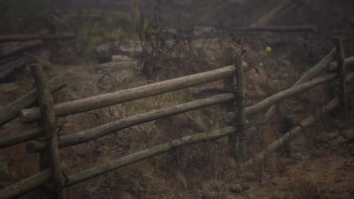An Old Wood Fence with a Country Field Behind It