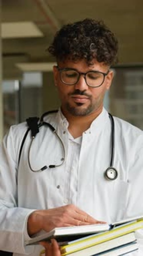 Doctor Student Intern Reading Medical Book in Hospital