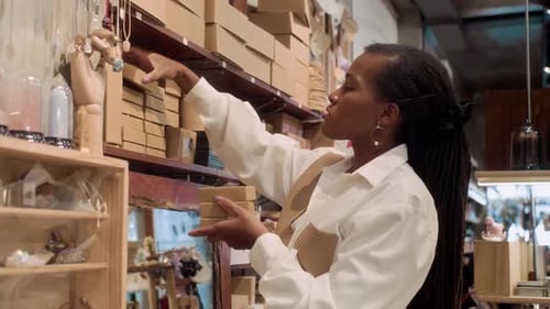 Female Worker Organizing Shelves in Store