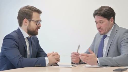 Middle Aged Businessman Talking with Customer in Office