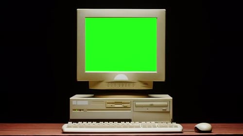 Old Computer with Green Chroma Key Screen Closeup Desktop PC Isolated on Black Background