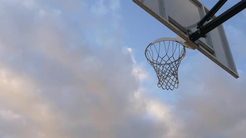 Man Dunks Basketball on Outdoor Court