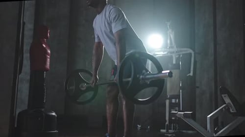 Man Doing Deadlifts in Gym