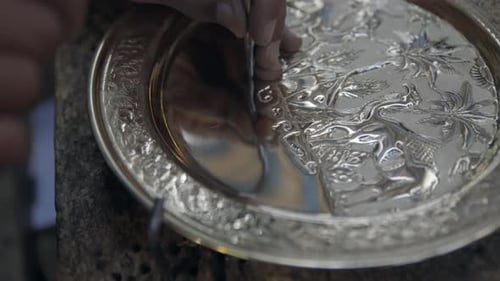Man Engraving Pattern On Brass Silver Plate On Shops In Medina of Tunis, Tunisia. Closeup