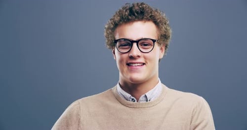 Smiling Young Adult Makes Heart Shape With Hands