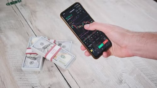 Adult Analyzing Stock Chart on Mobile Phone