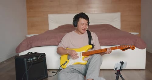 Man Plays Electric Guitar At Home