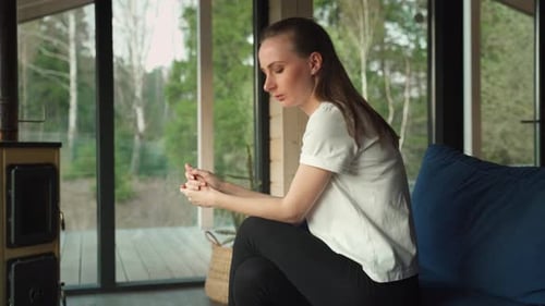 Distressed Woman Sitting on a Sofa Looking Sad