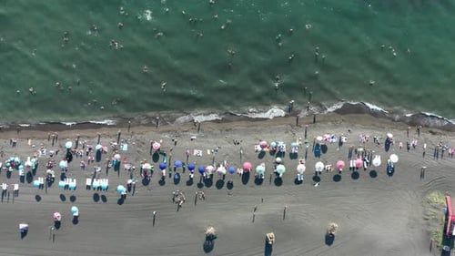 Aerial view touristic beach near Black sea. Sandy beach with colorful umbrellas.
