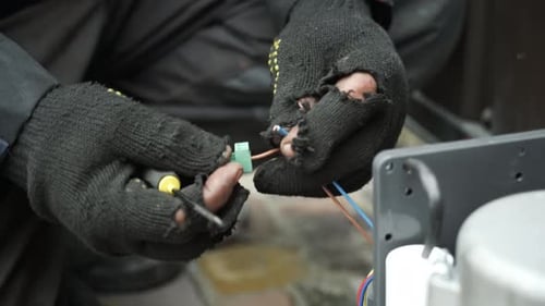 Technician Repairs Colored Electrical Wires Close Up