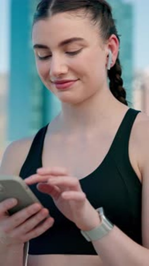 Athlete, smartphone and woman with earphones in city, fitness and song selection on web and online