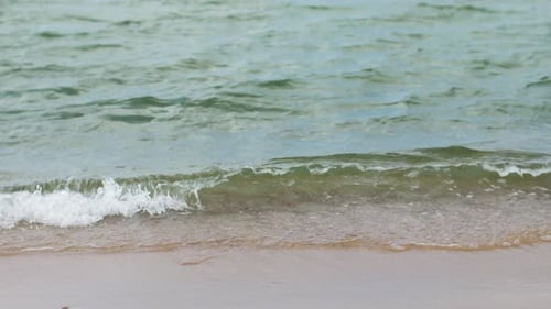 Ocean waves gently rolling on a beautiful summer beach seascape
