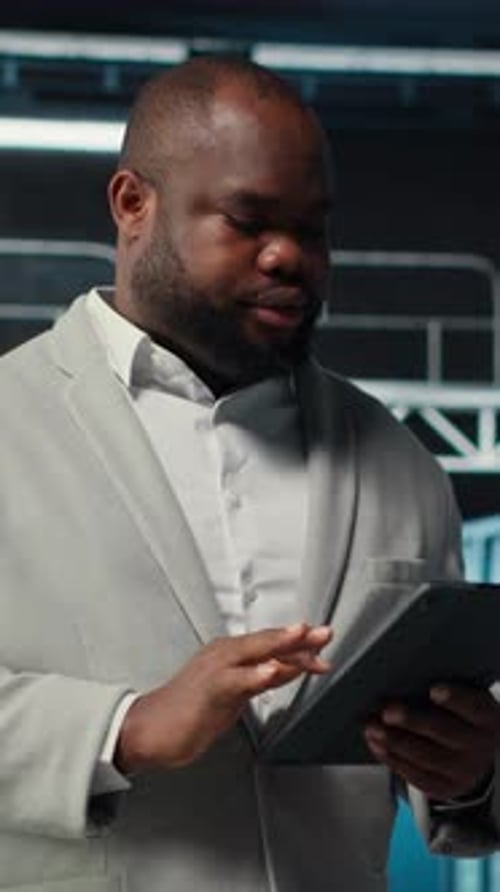 Vertical Video Smiling Data Center Technician Installing Server Racks Systems Using Tablet