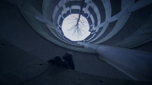 Hooded Fearless Woman Walking in Abandoned Urban Town at Twilight Light