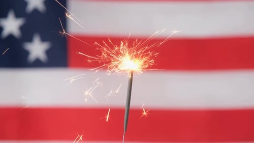 Sparkling Sparkler Against an American Flag Background