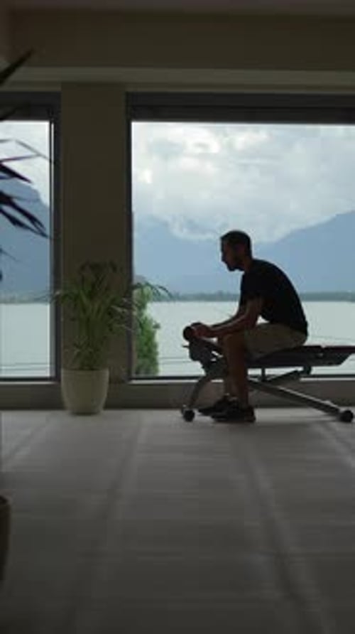 A Man Exercises While Enjoying a Scenic View of Beautiful Water and Majestic Mountains
