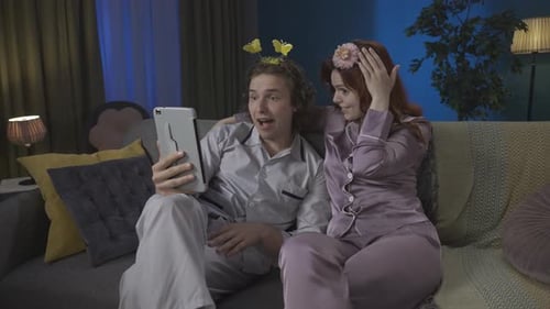 Couple in Pajamas Video Calling at Home