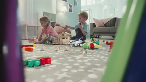 Children Play with Toys and Blocks Indoors