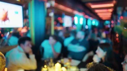 A Beautifully Defocused Background of a Lively Restaurant Atmosphere Featuring Colorful Lighting and