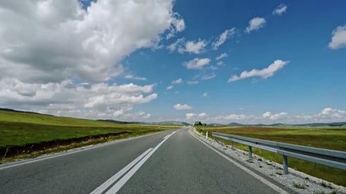 Driving Along a Motorway Through Green Fields