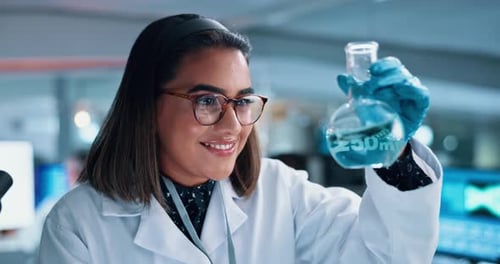 Scientist Inspecting Flask of Liquid in Laboratory