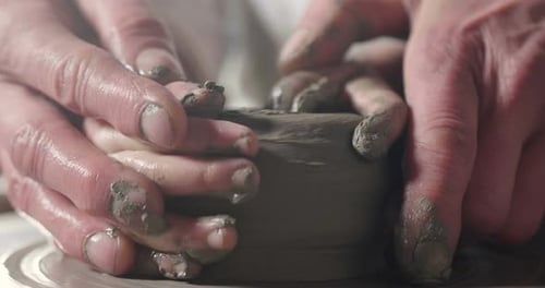 Hands Molding Clay on Pottery Wheel Close Up