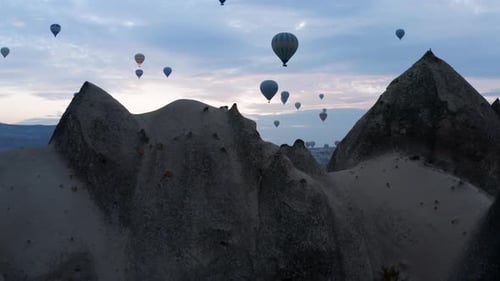 Hot Air Balloons Flying In Sunrise Sky In Cappadocia, Turkey - aerial drone shot