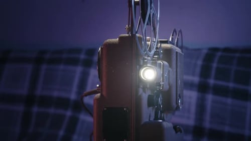 Vintage Film Projector Operating in Dimly Lit Room
