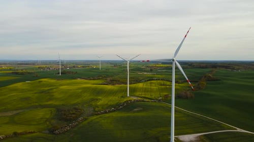 Scenic Aerial View of Wind Turbines Farm in Agricultural Field Rotating Blades of Windmill