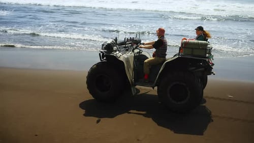 Active Touristic Trip To Sea Man And Woman Riding By Big Tire ATV In Sunny Day Amazing Seascape