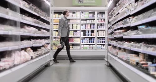 Adult male dancing in a grocery store